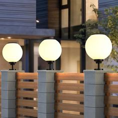 three lamps sitting on top of cement blocks