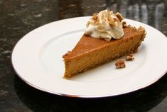 a slice of pumpkin pie on a white plate