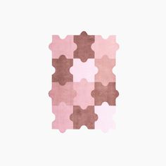 a pink and brown area rug on a white background with the shape of a puzzle piece