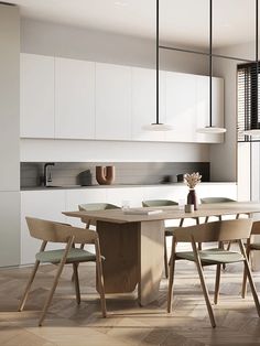 a dining table and chairs in a room with white cabinets, wood flooring and wooden floors