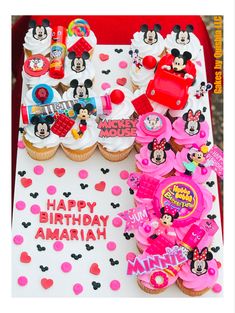 birthday cupcakes and mickey mouse decorations are on display at a minnie mouse themed birthday party