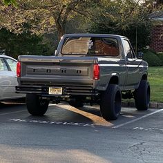 two trucks parked in a parking lot next to each other