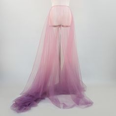 a mannequin dressed in pink and purple tulle with a dress on display