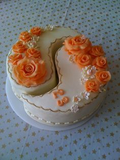 a white cake with orange roses on it