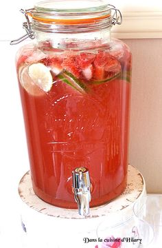 a glass jar filled with watermelon and ice