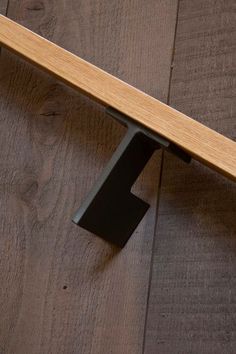 a wooden bench sitting on top of a floor next to a wood flooring wall