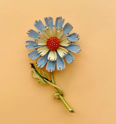 This is a vintage flower brooch. The flower is blue, yellow, and orange with a green stem. It is approximately 3 inches long and 1-1/2 inches wide. It has some small imperfections due to its age. Yellow Vintage Brooch For Party, Vintage Orange Brooches For Gifts, Yellow Flower-shaped Retro Jewelry, Vintage Enamel Flower Brooches, Blue Yellow Orange, Vintage Yellow Flower Brooch, Mid Century Jewelry, Flower Brooch, Vintage Love