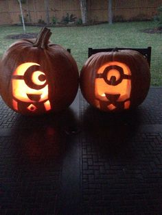 two pumpkins with faces carved into them