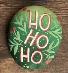 a green button with the words ho ho on it sitting next to a blue bowl