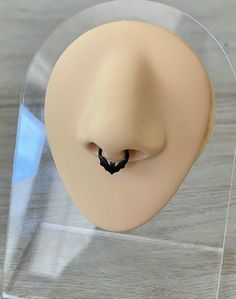 a plastic head with a bat on it's nose in a clear acrylic display case