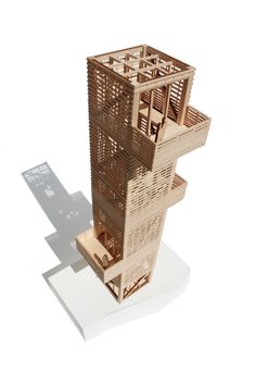 an architectural model of a tall building with balconies on the top and bottom floors