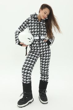 This black and white ski jumpsuit with houndstooth print is the perfect piece for those cold winter days. Made from rainwear, matte, waterproof fabric and insulated with polyester filler, this fitted black snowsuit was made to take on the cold. Original design will give you a good mood. A high-quality zip fastening, multiple pockets on the chest and hips, as well as an internal phone pocket and a ski pass pocket on the sleeve will ensure your comfortable skiing. The ski suit also has a hood. The set includes mittens. Choose your size from the chart and show the world you believe that cold winter days are meant for stylish displays! And if on top of this, you are a passionate skier or snowboarder, this ski suit for women will be the great choice for your next sports vacation. Don't hesitate Womens Snowsuit, Ski Suits For Women, Ski Jumpsuit, Ski Pass, Ski Coat, Suit For Women, Ski Suit, Ski Suits, Houndstooth Pattern