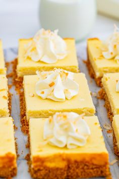 there are many squares of cake with white frosting on them and one is cut in half