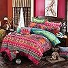 the bed is covered with colorful comforters and pillows, along with other decorative items