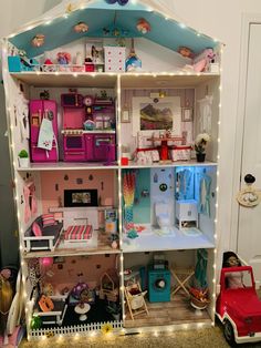 a doll house with lots of furniture and lights