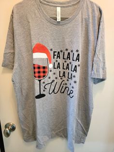 a gray t - shirt with the words fala la la la wine printed on it