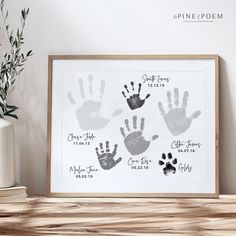 a family tree with handprints on it in front of a vase and books