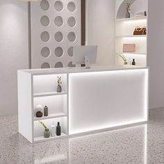 a white reception desk with shelves and lights