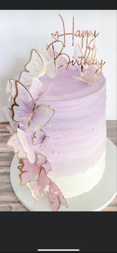 a cake with purple frosting and butterflies on top