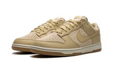 The Nike Dunk Low “Khaki/Gum” is a colorway of the retro basketball shoe with a tan-based look.  Another versatile edition of the Dunk Low, the upper features a combination of Khaki-colored suede and leather panels.  More specifically, Wheat Grass-colored suede is seen on the base while Rattan leather panels and Swoosh branding create low contrast color and texture.  A burnt orange “Nike” logo is embroidered on the heel and printed on the tongue tag above a Swoosh.  Underfoot, a cream-colored ru Tan Dunks, Burnt Orange Nike, Retro Basketball Shoes, Retro Basketball, Wheat Grass, December 21, Stadium Goods, Nike Dunk Low, Dunk Low