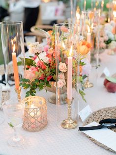 a table topped with lots of candles and flowers