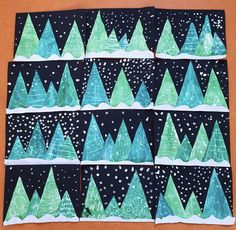 four pieces of paper with trees painted on them and snow falling from the sky in the background