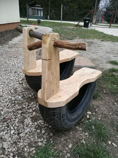 a wooden bench sitting on top of a tire