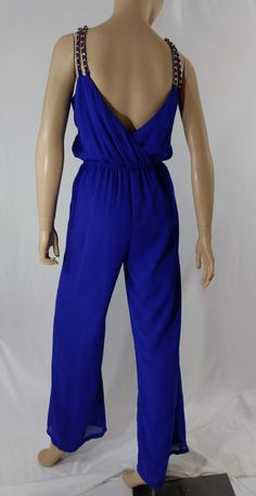 "Women's Jumpsuit Neon Blue Sleeveless Vintage Size S Easy to wear, gorgeous! Neon blue jumpsuit, sleeveless, V neckline, cross over front, elastic waistline, full length, double gold chain straps, fully lined, semi sheer fabric over solid. High quality. Excellent LIKE NEW condition. Easy to wear casual chic vintage for the disco sporting life. MEASUREMENTS: Length - 58.5\" Inseam - 31\" Waist - 26\" unstretched Bust (underarms to underarms) - 37\" Hips - 19\"x2 MODEL STATS: Ht. - 5' 8.5\" Bust Chic Blue Stretch Strapless Jumpsuit, Chic Blue Strapless Stretch Jumpsuit, Blue Stretch Sleeveless Jumpsuit, Blue Stretch Sleeveless Jumpsuits And Rompers, Blue Sleeveless Stretch Jumpsuit And Romper, Blue Sleeveless Stretch Jumpsuits And Rompers, Chic Blue Sleeveless Jumpsuits And Rompers, Blue Strapless Jumpsuit For Spring Party, Blue Fitted Strapless Sleeveless Jumpsuit