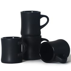 three black coffee mugs stacked on top of each other with one cup in the middle