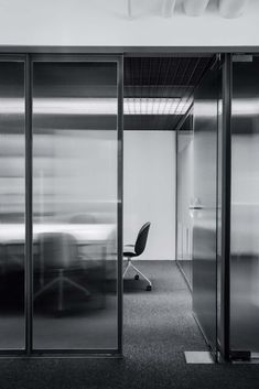 an office with glass walls and sliding doors