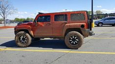 an orange jeep parked in a parking lot