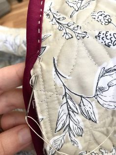 someone is stitching on the side of a piece of fabric that has been sewn together