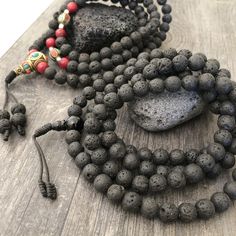 Everyday black lava stone mala necklace. You can choose between 2 styles. 1- A Mala necklace that is all black lava stones which is 43cm- 17 inch long (there is no clasp, you wear it over the head) 2-A Mala necklace which has black lava stones, red beads and unique Nepali beads. This Mala is 48cm- 19 inch long ( there is no clasp, you wear it over your head) This unique unisex mala necklaces can be a diffuser necklaces also, as you can choose which ever oil that you like to use with the lava roc Holistic Black Round Beaded Jewelry, Holistic Black Round Beads Jewelry, Spiritual Black Natural Stone Beads, Handmade Black Mala As Gift, Adjustable Black Mala With Round Beads, Black Natural Stones Beads For Meditation, Black Mala With Round Beads For Gift, Black Spiritual Mala For Healing, Black Mala With Round Beads