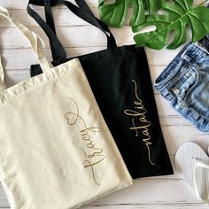 two personalized tote bags sitting on top of a wooden floor next to shoes