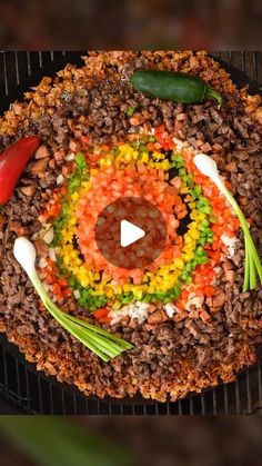 a grill with food on it that looks like an eyeball in the middle and vegetables around it