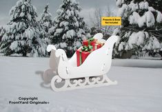 a sleigh with presents wrapped in red and green bows on it is sitting in the snow