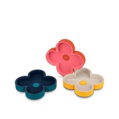 three flower shaped dishes sitting next to each other