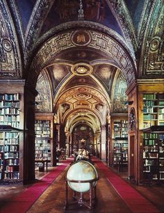 an old library with lots of books on the shelves