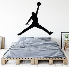 a basketball player jumping up to dunk the ball wall decal in a bedroom