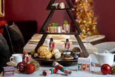 a christmas tree made out of cookies on a table with other holiday treats and decorations