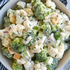 a bowl filled with broccoli and cauliflower on top of a table