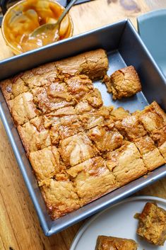 a pan filled with food sitting on top of a wooden table