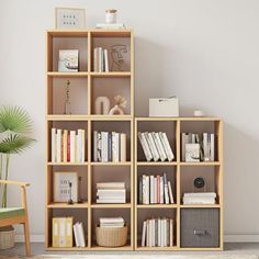 a book shelf with many books on it and a chair in the corner next to it