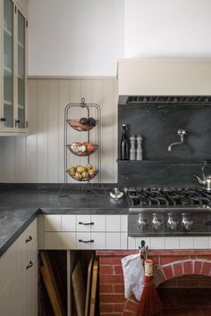 a stove top oven sitting inside of a kitchen next to a brick oven and counter