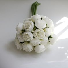 a bouquet of white flowers sitting on top of a table