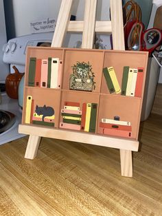 a wooden easel with books on it