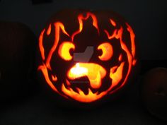 a pumpkin carved to look like a dog's face with flames coming out of it