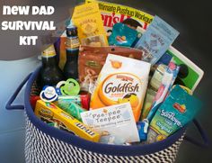 the new dad survival kit is packed in a basket with snacks, drinks and snacks