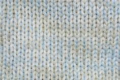 an up close shot of a blue and white knitted sweater