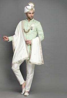 Art Silk Sherwani in Light GreenThis Readymade attire is Enhanced with Buttons and Resham Work. Crafted in Chinese Collar Neck and Full SleeveAvailable with an Art Silk Pant in Off WhiteDo note: Turban, Kanthimala, Dupatta, Brooch and Footwear shown in the image is for presentation purposes only. Half to one inch may vary in measurement. In case you want to purchase the Dupatta (WEBSITE ITEM CODE: MXX300). (Slight variation in actual color vs. image is possible) We sell all kinds of menswear. Me Anarkali Sherwani With Chikankari Embroidery In Chanderi, Anarkali Style Sherwani With Resham Embroidery In Art Silk, Ceremonial Sherwani With Zari Work In Chanderi, Semi-stitched Embroidered Anarkali Sherwani, Ceremonial Semi-stitched Chanderi Sherwani, Anarkali Sherwani With Zari Work In Straight Kurta Style, Anarkali Sherwani With Zari Work, Anarkali Style Sherwani With Zari Work, Embroidered Semi-stitched Sherwani